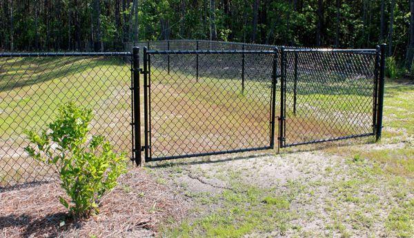 Black chain link double gate for residential driveway in Kyle, TX