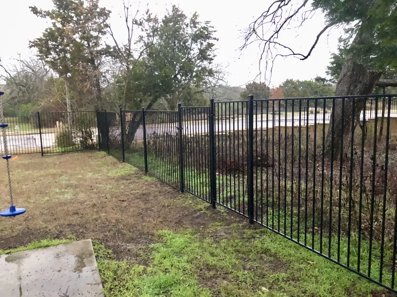 Black metal fence installation Kyle TX