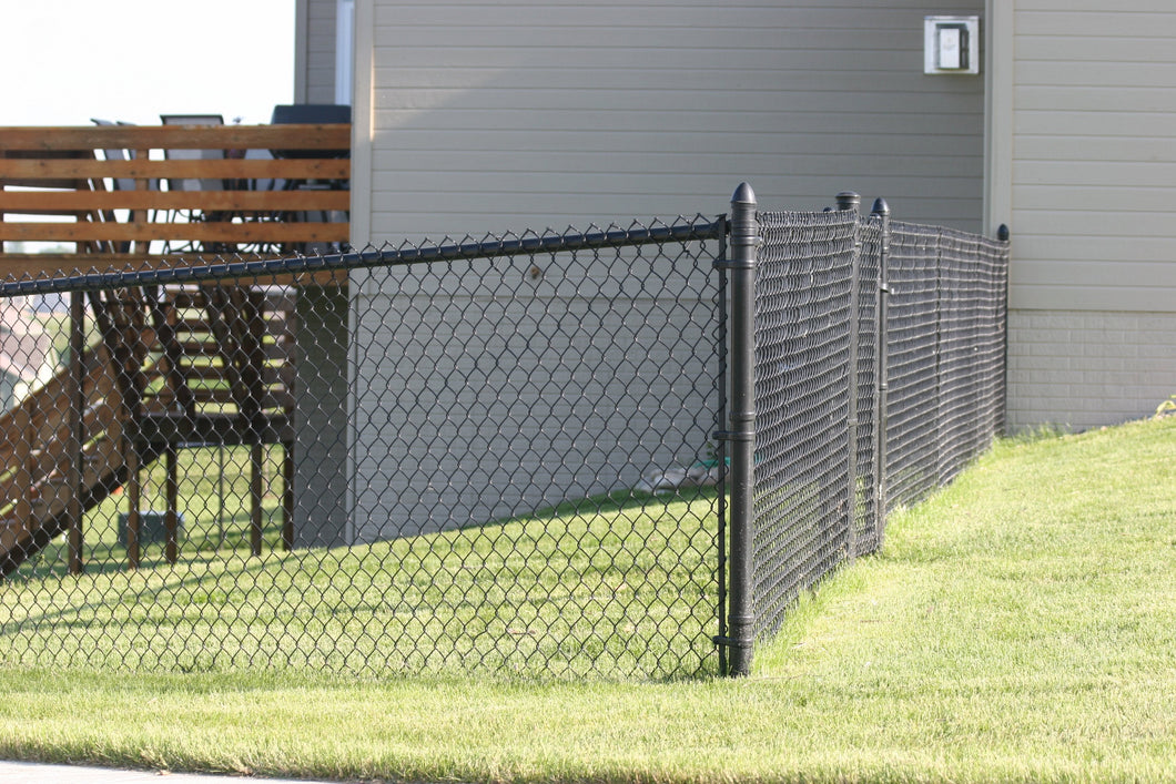 Black vinyl chain link fence for residential backyard privacy in Buda, TX