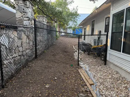 Black vinyl-coated chain link fence installation in Austin, TX