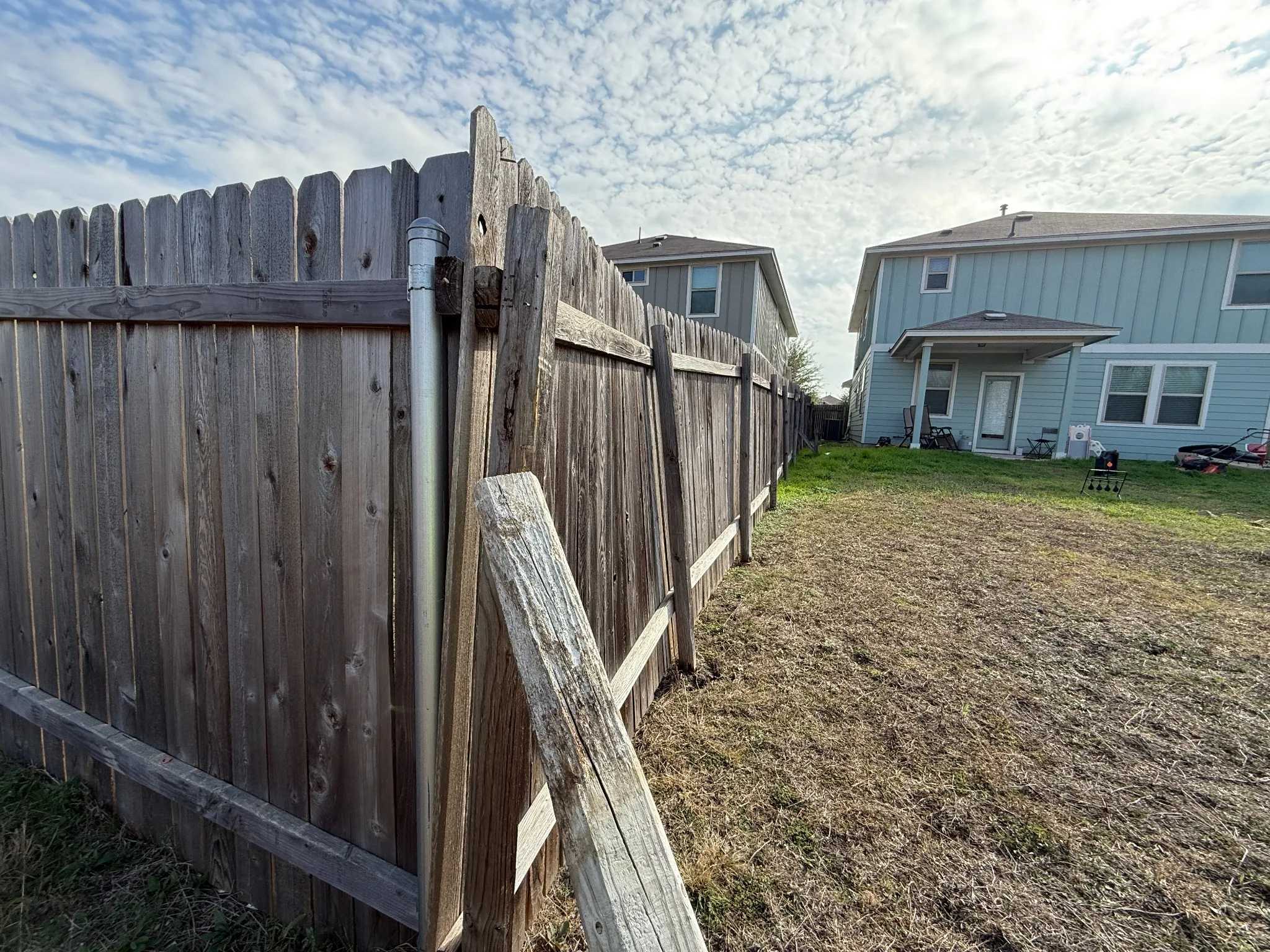 Leaning fence section needing post repair in Austin, TX