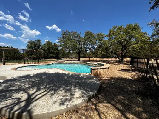 Black metal fence installation around pool in Austin, TX