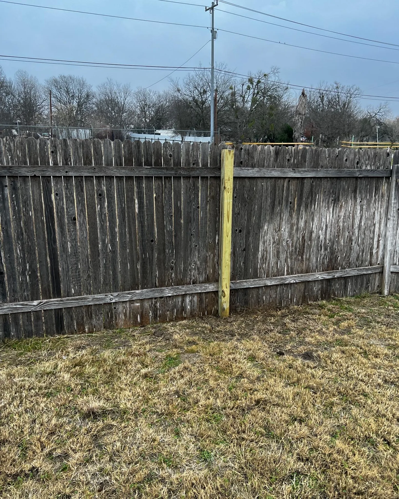 Rotted fence post at ground level needing replacement in Buda, TX